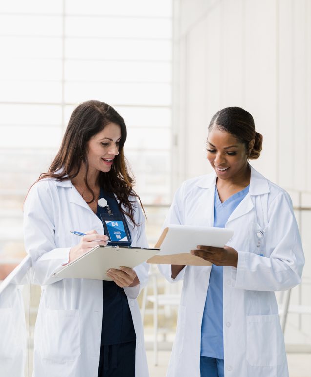 Female Physicians Reviewing Paperwork